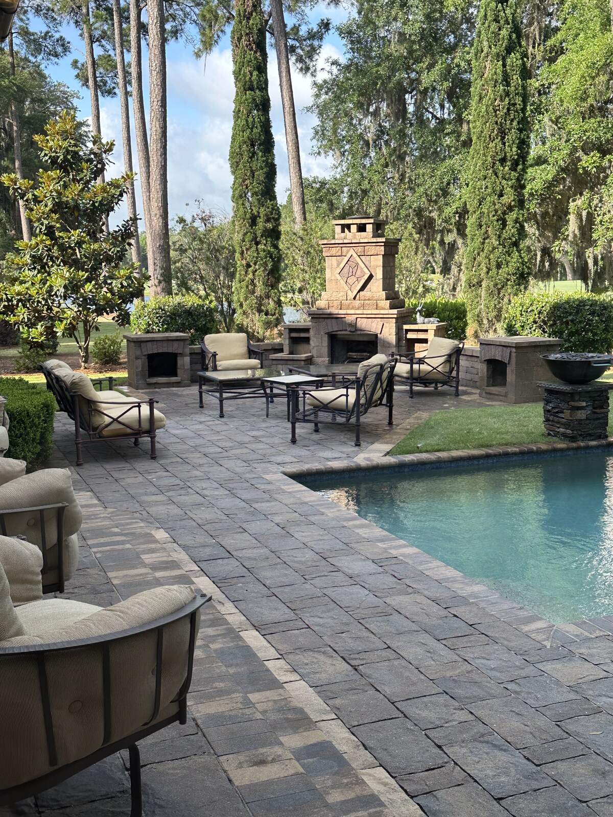 Poolside luxury patio with stone fireplace